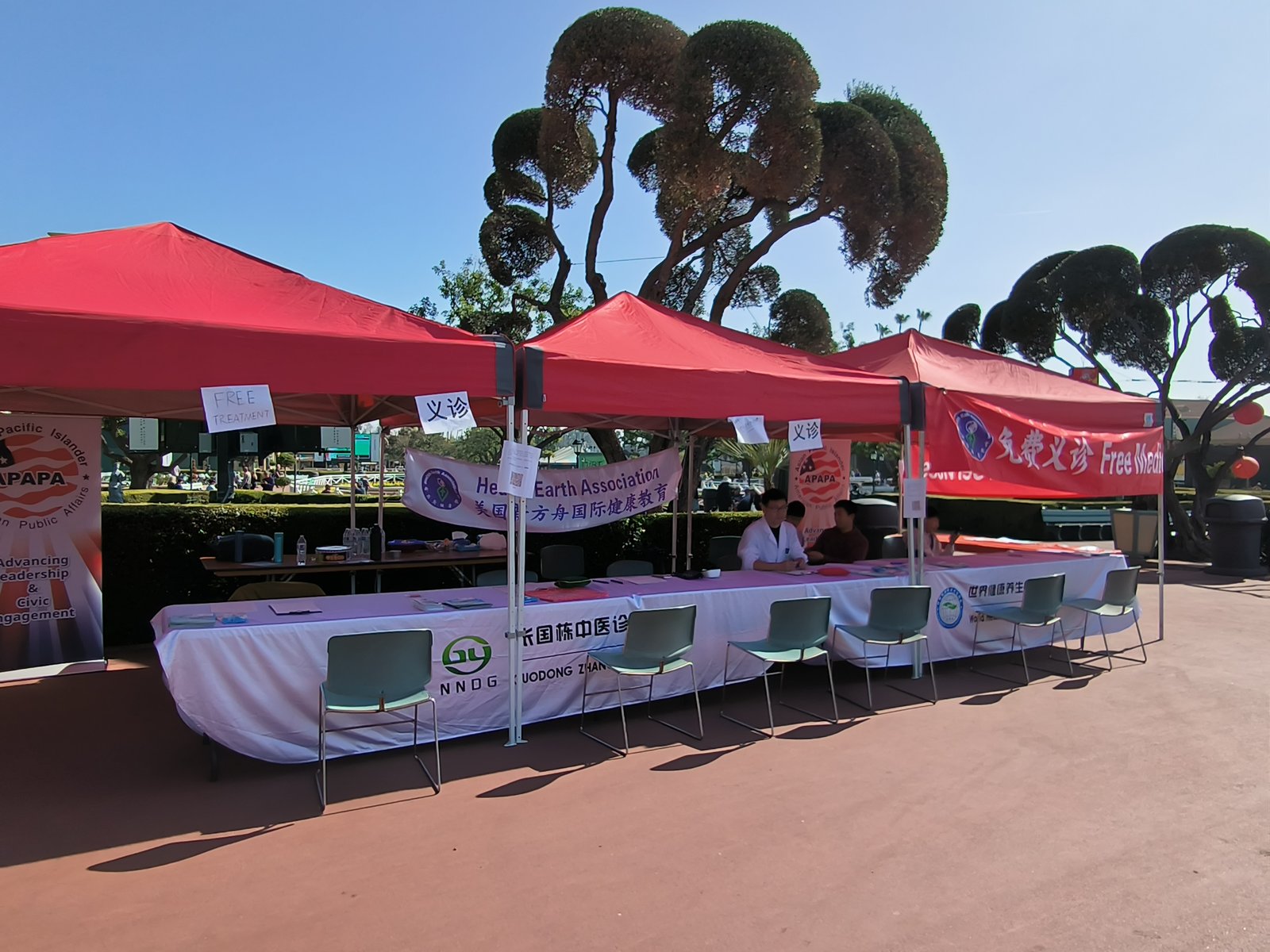 Volunteer community clinic tents at an outdoor wellness day in Arcadia