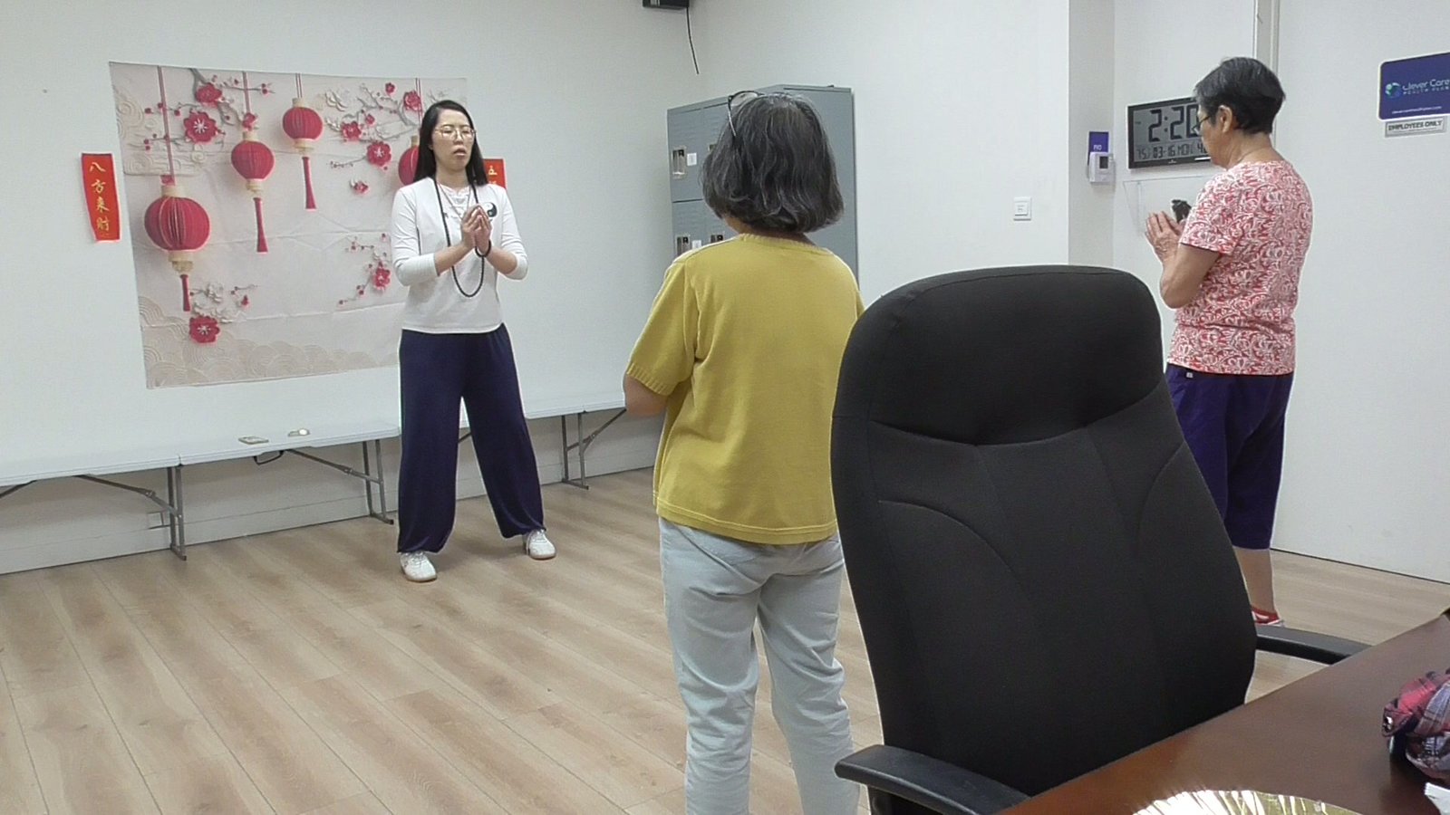 A weekly senior qigong class in session, students following the instructor, seen from behind